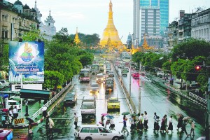 Traffic moves along a busy downtown street in Yangon