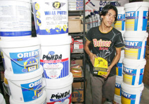 A salesperson handles construction materials at a store in Yangon.