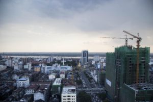 Construction cranes loom large above a high-rise development on the corner of Sule Pagoda and Anawratha Roads in downtown Yangon.  