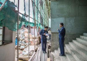 Yangon City Development Committee officials inspect a high-rise project in Yangon.